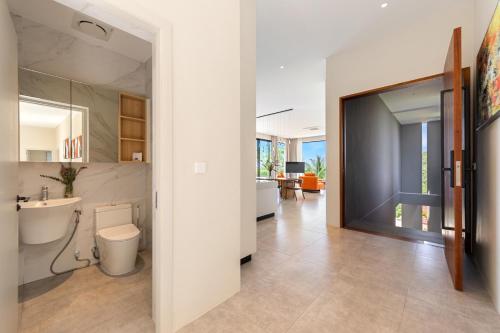 a bathroom with a sink and a toilet in a room at Green Lotus Samui in Ban Bang Po