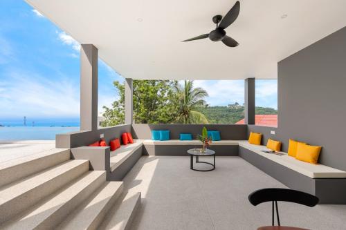 a living room with a view of the ocean at Green Lotus Samui in Ban Bang Po