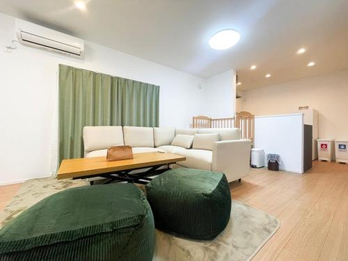 a living room with a couch and a table at Port House Fukuoka in Fukuoka