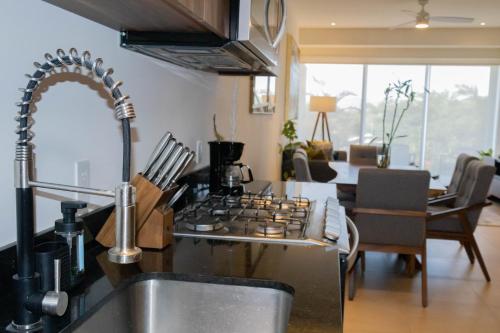a kitchen with a sink and a stove top oven at Dtoscana Residencial-Nuevo Vallarta in Nuevo Vallarta