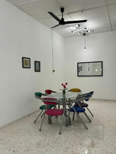 a table and chairs in a room with a ceiling at Yipstay Gopeng HomeTown in Gopeng