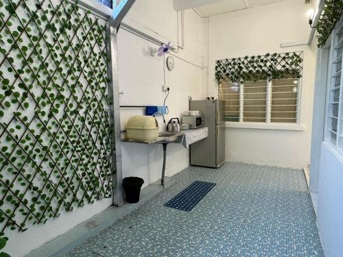 a small kitchen with a counter and a refrigerator at Yipstay Gopeng HomeTown in Gopeng