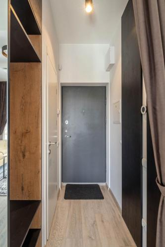 a hallway with a sliding door in a house at Cozy Palanga Apartment in Palanga