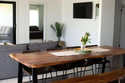 a living room with a wooden table and a couch at Home Away From Home - Contemporary Sophistication in Dubbo