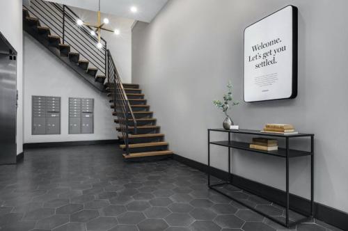 a hallway with a staircase and a table in a room at The Frankford Fishtown in Philadelphia