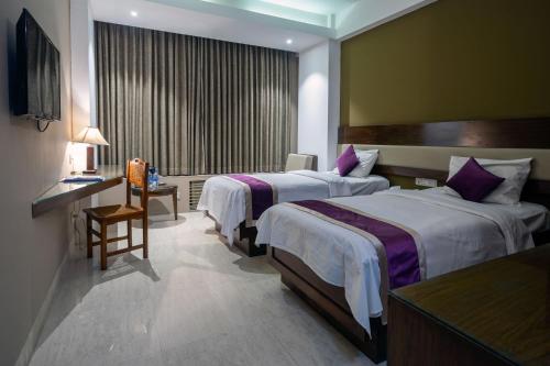 Postel nebo postele na pokoji v ubytování Hotel Ashrafee
