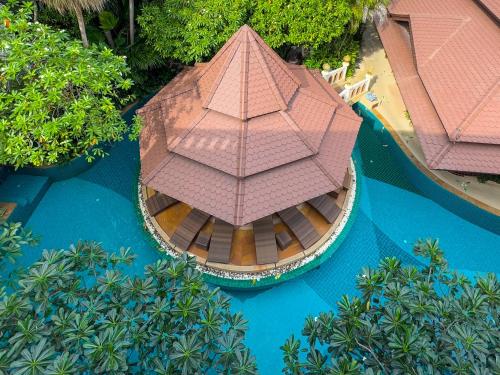 an overhead view of a boat with a large umbrella at Quality Beach Resorts and Spa Patong in Patong Beach
