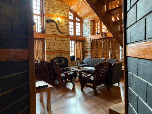 a dining room with chairs and a table in a building at Into The Wild Manali in Vashisht