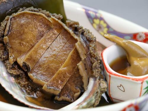 a pie in a bowl next to a cup of dipping sauce at Iwanai Kogen Hotel in Iwanai