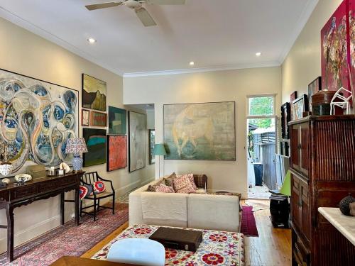 a living room with a couch and a table at Art-Filled Designer Terrace in Chic Woollahra in Sydney