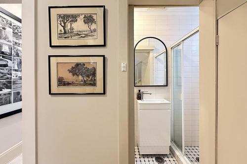 a bathroom with a sink and a mirror at Art-Filled Designer Terrace in Chic Woollahra in Sydney