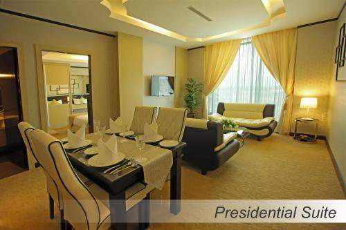 a room with a dining table and a living room at Casuarina@Meru in Ipoh