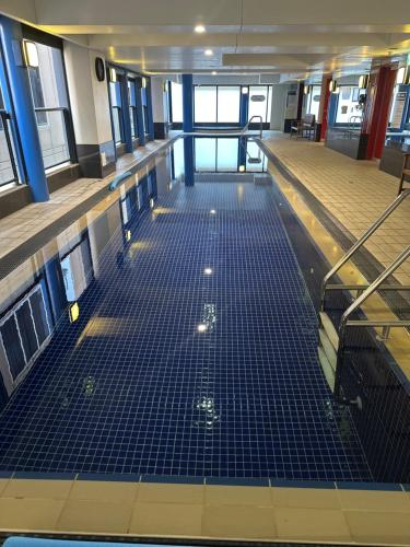an empty room with blue tiles on the floor at North Terrace Horizons free parking in Adelaide