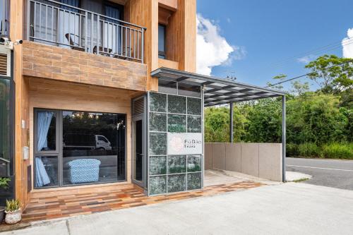 a building with a large glass window on the side of it at Kenting Fu Bao Inn in Hengchun