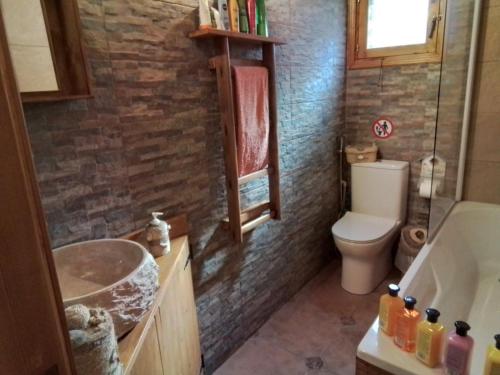 a bathroom with a sink and a toilet and a tub at Despina country retreat in Paphos City