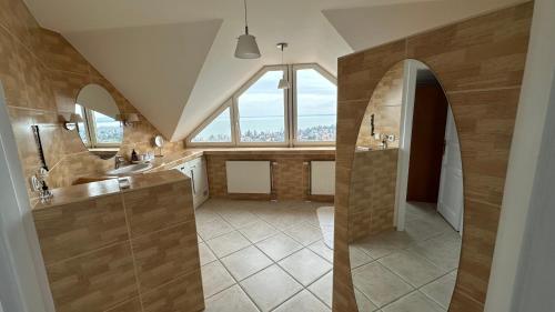 a bathroom with two sinks and a large window at Villa Kamilla in Balatongyörök