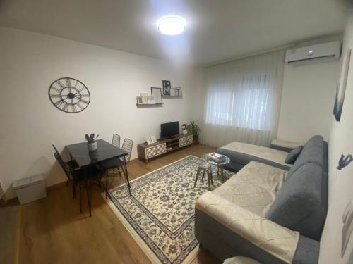 a living room with a couch and a table at Apartman Esma in Novi Pazar