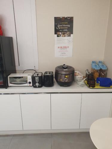 a kitchen counter with a toaster and a microwave at HOTEL LENITH Seomyeon in Busan