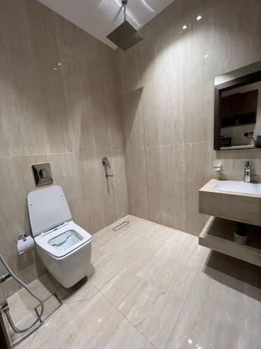 a bathroom with a toilet and a sink at استديو أنيق كلاسيكي in Riyadh
