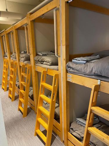 a row of bunk beds in a room at Dogen sauna&stay in Tokyo