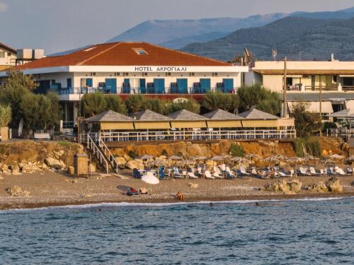 a hotel on a beach next to the water at Akrogiali in Kyparissia