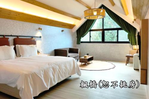 a bedroom with a large white bed and a chair at Tingtau Villa in Lugu