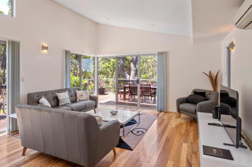a living room with a couch and a table at Alkira @ Cape Villas Dunsborough in Dunsborough