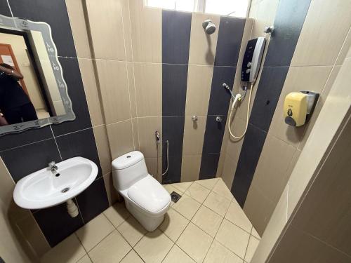 a small bathroom with a toilet and a sink at Radiant Heights Hotel by KK Inn in Ampang