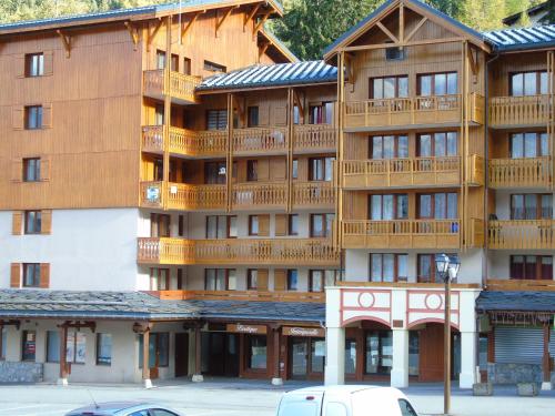 a large wooden building with balconies on it at Studio cosy 2/3 pers, proche remontées & commerces à Valfréjus - FR-1-561-88 in Valfréjus