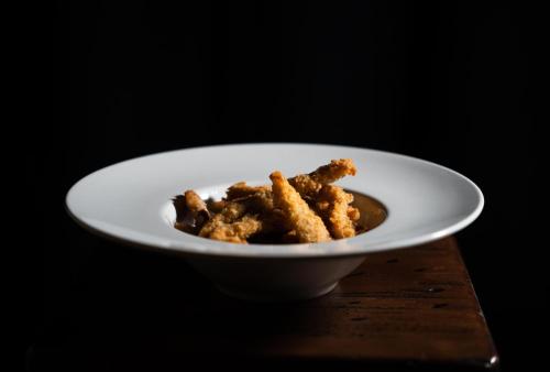 a white bowl of food on a table at The Central House Porto Ribeira in Porto