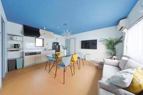 a kitchen and living room with a table and chairs at Ryugu -竜宮- in Osaka