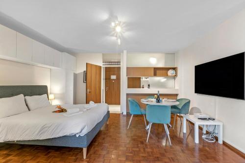 a bedroom with a bed and a table and a kitchen at La Perla Sul Lago - Happy Rentals in Paradiso