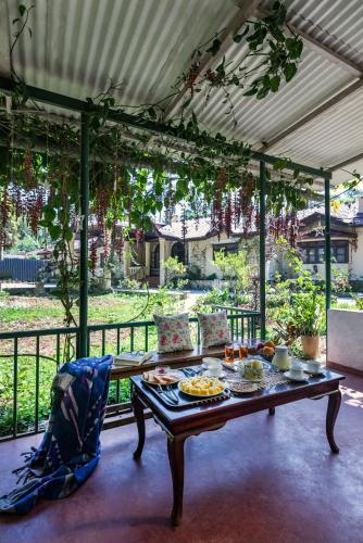 a table with food on it on a patio at SaffronStays Calamondinn Bungalow, Coorg in Gonikoppal