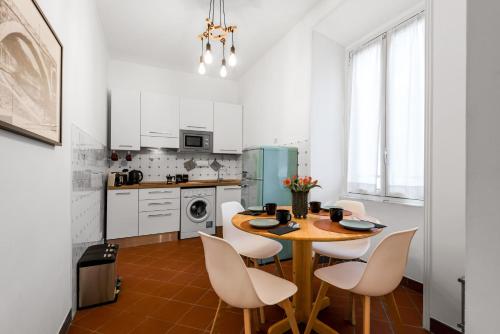 a kitchen with a table and chairs in a room at Piazza Testaccio Home apt E1- Luminoso con vista piazza Testaccio in Rome