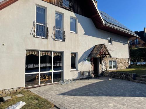 a building with large windows on the side of it at Winnica Spisz in Łapsze Niżne