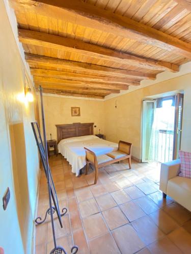 a bedroom with a bed and a table in a room at Casa di montagna nei monti simbruini in Trevi nel Lazio