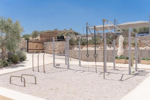 a playground in a park with a swing set at WHITE DONKEY BOUTIQUE Hotel in Chrani