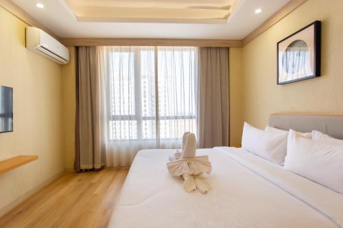 Ένα ή περισσότερα κρεβάτια σε δωμάτιο στο The Q Hotel & Suite Vientiane 万象Q套房酒店