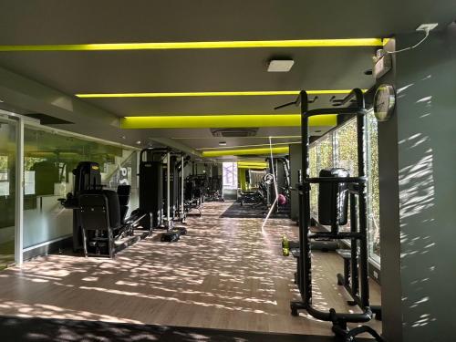 a gym with a row of treadmills and machines at jasminespace in Khlong San
