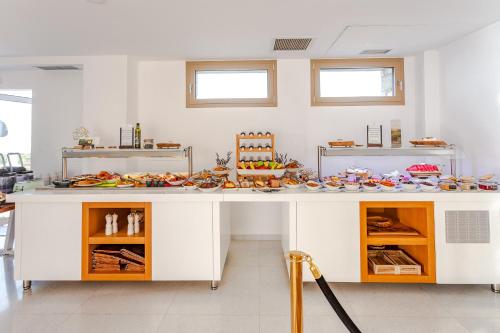 a kitchen with a counter with food on it at WHITE DONKEY BOUTIQUE Hotel in Chrani