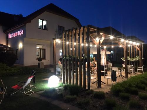 a group of people sitting in a yard at night at Hotel Sulbin in Garwolin