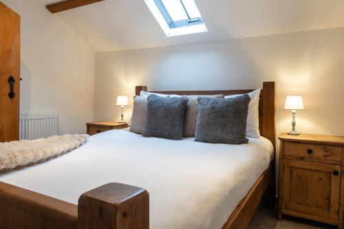 a bedroom with a large bed with two night stands at The Coach House - Beautiful Home in Cheltenham! in Cheltenham