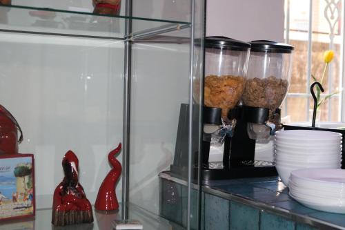 a glass shelf with bowls and other items on it at MaryGrace B&B in Castellammare di Stabia