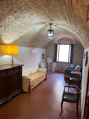 a living room with a couch and a table at Casa dell Erbe in San Gimignano