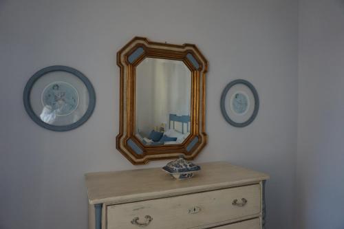 a mirror on top of a dresser in a room at Viareggio, Sweet home in Viareggio