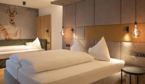 a hotel room with two beds and a giraffe mural at Hotel Lamtana in Ischgl