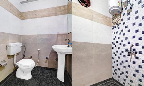 a bathroom with a toilet and a sink at Hotel Pragati Heights in Mathura