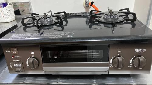 a stove with two burners on top of it at Feliz Kumamoto in Kumamoto
