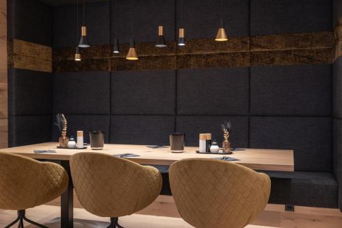 a dining room with a table and chairs at Hotel Lamtana in Ischgl