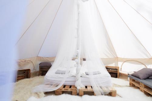a bedroom with a bed in a tent at Lawendowa Osada in Przywidz